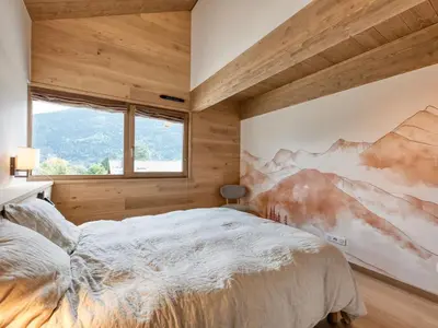 a bedroom with a large bed with a wooden ceiling at Chalet familial 5 chambres, proche ski, vue Mont-Blanc, parking et WiFi - FR-1-663-28 in Saint-Gervais-les-Bains