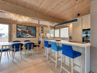 a kitchen with a large white island with blue bar stools at Chalet familial 5 chambres, proche ski, vue Mont-Blanc, parking et WiFi - FR-1-663-28 in Saint-Gervais-les-Bains