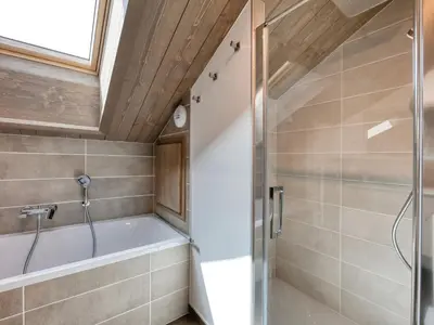 a bedroom with a large bed and a wooden ceiling at Chalet familial 5 chambres, proche ski, vue Mont-Blanc, parking et WiFi - FR-1-663-28 in Saint-Gervais-les-Bains