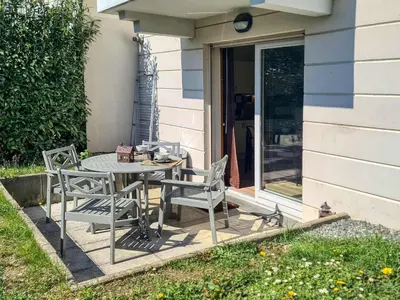 a table and chairs sitting on a patio at Saint-Gervais : Appartement rénové 2 ch, jardin, WiFi & parking - FR-1-663-34 in Saint-Gervais-les-Bains