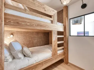 a kitchen with a wooden table with chairs and a dining room at Saint-Gervais : Appartement rénové 2 ch, jardin, WiFi & parking - FR-1-663-34 in Saint-Gervais-les-Bains