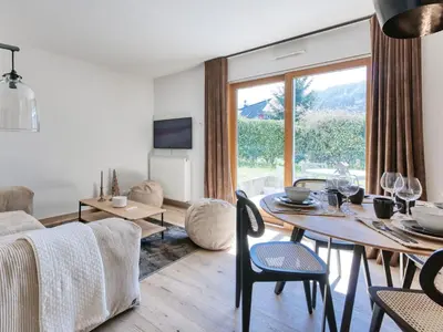 a bedroom with a large bed with a brick wall at Saint-Gervais : Appartement rénové 2 ch, jardin, WiFi & parking - FR-1-663-34 in Saint-Gervais-les-Bains
