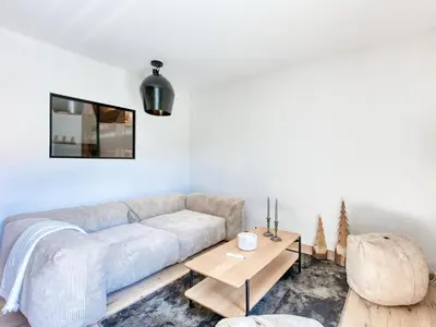 a dining room with a wooden table and chairs at Saint-Gervais : Appartement rénové 2 ch, jardin, WiFi & parking - FR-1-663-34 in Saint-Gervais-les-Bains