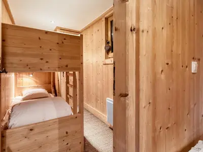 a bedroom with a bed in a wooden room at Chalet familial à Saint-Gervais, 6 chambres, 12 pers, WiFi, parking - FR-1-663-27 in Saint-Gervais-les-Bains