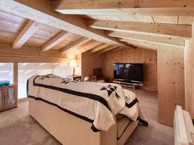 a living room with a red couch and wooden walls at Chalet familial à Saint-Gervais, 6 chambres, 12 pers, WiFi, parking - FR-1-663-27 in Saint-Gervais-les-Bains