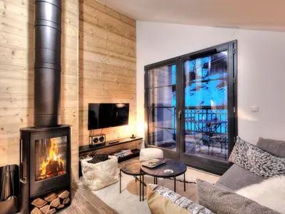 a living room with a fireplace and a tv at Appartement cosy avec cheminée et parking, proche centre - FR-1-663-38 in Saint-Gervais-les-Bains