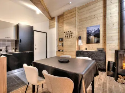 a balcony with a table and chairs on it at Appartement cosy avec cheminée et parking, proche centre - FR-1-663-38 in Saint-Gervais-les-Bains