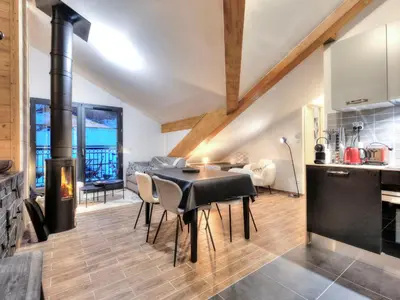 a bedroom with a large white bed with a patterned wall at Appartement cosy avec cheminée et parking, proche centre - FR-1-663-38 in Saint-Gervais-les-Bains