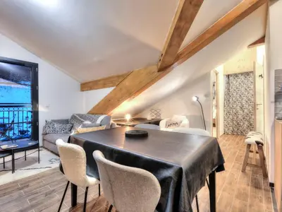 a living room with a couch and a table at Appartement cosy avec cheminée et parking, proche centre - FR-1-663-38 in Saint-Gervais-les-Bains
