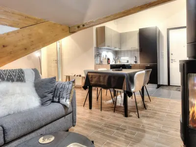 a living room with a table and chairs at Appartement cosy avec cheminée et parking, proche centre - FR-1-663-38 in Saint-Gervais-les-Bains