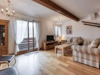 a kitchen and dining room with a wooden table and chairs at Appartement duplex avec vue montagne, 8 pers, parking, Wi-Fi - FR-1-663-36 in Saint-Gervais-les-Bains