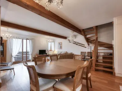 a dining room with a table and chairs and a couch at Appartement duplex avec vue montagne, 8 pers, parking, Wi-Fi - FR-1-663-36 in Saint-Gervais-les-Bains