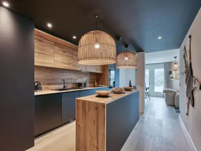 a kitchen with a large island in a room with white walls at Charmant appartement au centre, 4 pers, avec Wifi et parking - FR-1-663-44 in Saint-Gervais-les-Bains