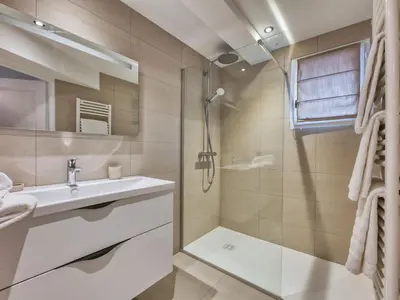 a bedroom with a large bed and a brick wall at Charmant appartement au centre, 4 pers, avec Wifi et parking - FR-1-663-44 in Saint-Gervais-les-Bains