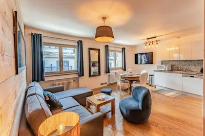 a living room with a couch and a table at Alpin chic au cœur de Chamonix in Chamonix-Mont-Blanc