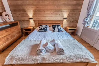 a bedroom with a bed with towels on it at Alpin chic au cœur de Chamonix in Chamonix-Mont-Blanc