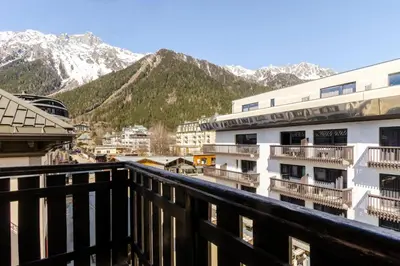 a view of the mountains from the balcony of a hotel at Alpin chic au cœur de Chamonix in Chamonix-Mont-Blanc