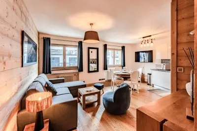 a living room with a couch and a table at Alpin chic au cœur de Chamonix in Chamonix-Mont-Blanc