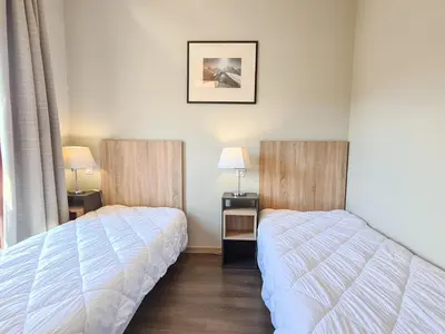 a bedroom with two beds and two lamps in it at Appartement spacieux Flain - Ski aux pieds et parking - FR-1-425-235 in Arâches-la-Frasse