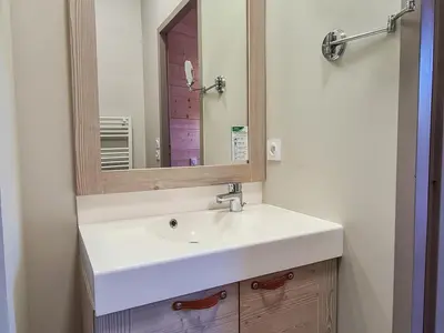 a bathroom with a white sink and a mirror at Appartement spacieux Flain - Ski aux pieds et parking - FR-1-425-235 in Arâches-la-Frasse