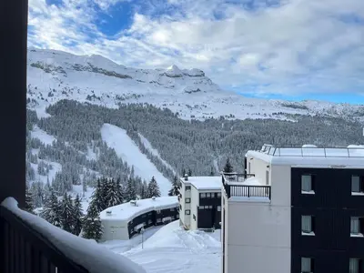 a view of a snow covered mountain from a building at Appartement spacieux Flain - Ski aux pieds et parking - FR-1-425-235 in Arâches-la-Frasse