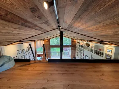 a large room with wooden floors and a large window at Chalet La Frasse in Chamonix-Mont-Blanc