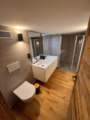 a bathroom with a white sink and a toilet at Chalet La Frasse in Chamonix-Mont-Blanc