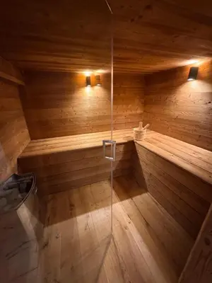 a bathroom with a sauna with a glass shower at Chalet La Frasse in Chamonix-Mont-Blanc