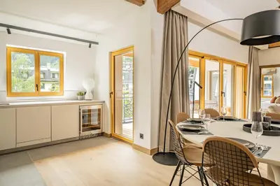 a kitchen and dining room with a table and chairs at Paradisa Penthouse in Chamonix-Mont-Blanc