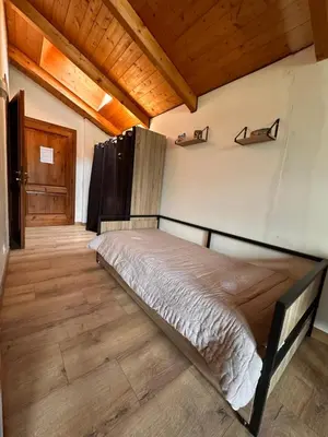 a bedroom with a bed in a room with wooden ceilings at OLCA Les Houches in Les Houches