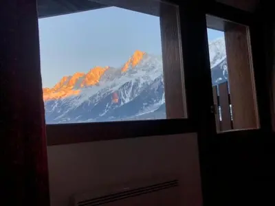 a bathroom door with a view of a snow covered mountain at OLCA Les Houches in Les Houches
