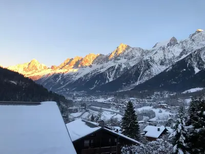 a view of a snowy mountain range with a town at OLCA Les Houches in Les Houches