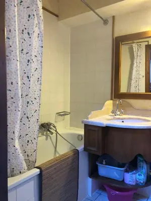 a bathroom with a sink and a tub and a mirror at OLCA Les Houches in Les Houches