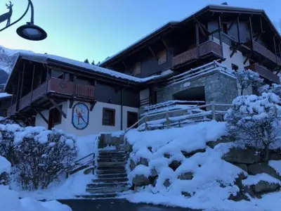 a house with snow on the ground in front of it at OLCA Les Houches in Les Houches