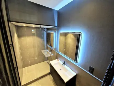 a bathroom with a sink and a mirror at Le Majestic Superbe Appartement Centre Chamonix in Chamonix-Mont-Blanc