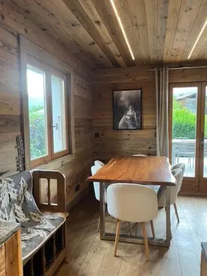 a wooden dining room with a table and chairs at Chalet Taïga face au Montblanc et à 7min de Megève in Combloux