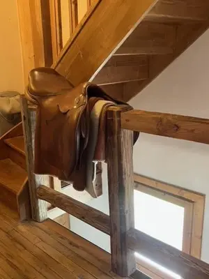 a leather purse hanging on the side of a staircase at Chalet Taïga face au Montblanc et à 7min de Megève in Combloux