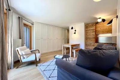 a living room with a couch and a table at Les Tulipes Blanches in Megève