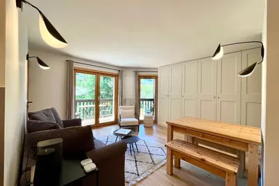 a living room with a couch and a table at Les Tulipes Blanches in Megève