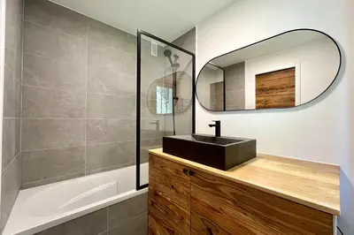 a bathroom with a sink and a mirror at Les Tulipes Blanches in Megève