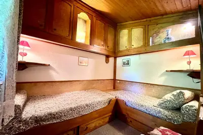 a small room with two beds in a cabin at Les Toits des Cateaux in Combloux