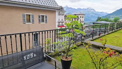 a balcony with a black fence and a plant at Appartement 14 - Résidence Conseil au coeur du village in Saint-Gervais-les-Bains