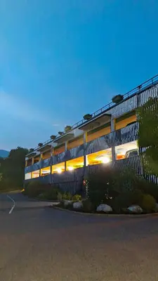 a building with lights on in a parking lot at Appartement 14 - Résidence Conseil au coeur du village in Saint-Gervais-les-Bains