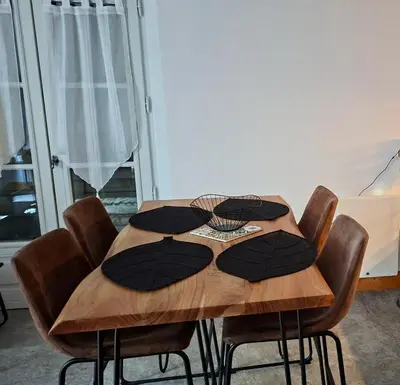 a dining room table with brown chairs and a wooden table at Appartement 14 - Résidence Conseil au coeur du village in Saint-Gervais-les-Bains