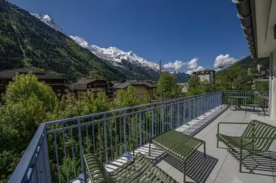 a balcony with chairs and a view of a mountain at Paradisa Terrasse Mont-Blanc Central 3-bedroom with Mont-Blanc View! in Chamonix-Mont-Blanc