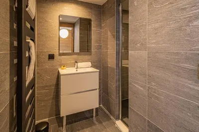 a bathroom with a sink and a mirror at Paradisa Terrasse Mont-Blanc Central 3-bedroom with Mont-Blanc View! in Chamonix-Mont-Blanc