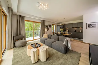 a living room with a couch and a table at Paradisa Terrasse Mont-Blanc Central 3-bedroom with Mont-Blanc View! in Chamonix-Mont-Blanc