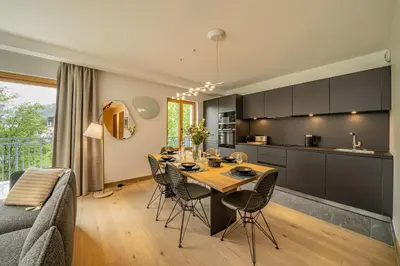 a kitchen and dining room with a table and chairs at Paradisa Terrasse Mont-Blanc Central 3-bedroom with Mont-Blanc View! in Chamonix-Mont-Blanc