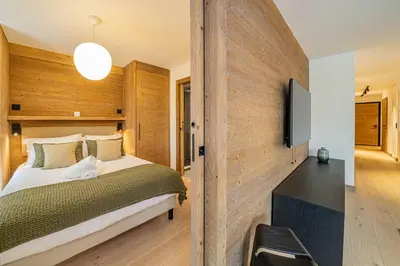 a bedroom with a large bed and a television at Paradisa Mer de Glace Elegant brand new 3-bedroom apartment in Chamonix-Mont-Blanc