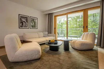 a living room with two couches and a table at Paradisa Mer de Glace Elegant brand new 3-bedroom apartment in Chamonix-Mont-Blanc